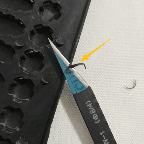 An image of a plastic part with a thin, unwanted edge of flash along the parting line.