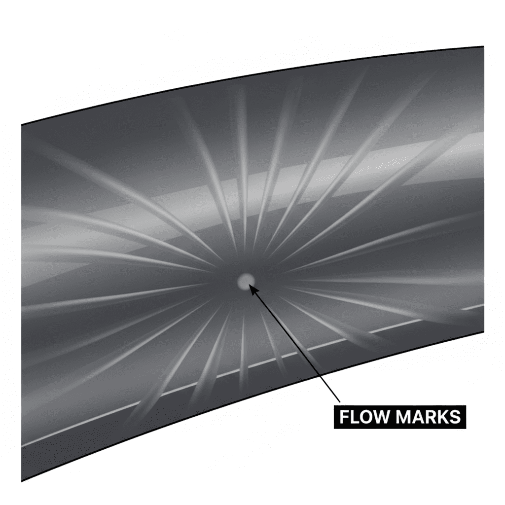 An image displaying flow marks on a dark, glossy plastic part, showing a wavy pattern.