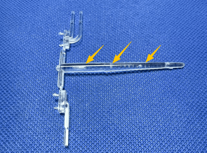 An X-ray view or cross-section of a plastic part showing internal bubbles.