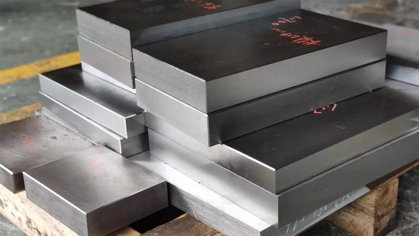 An assortment of different steel blocks for mold making in a workshop.