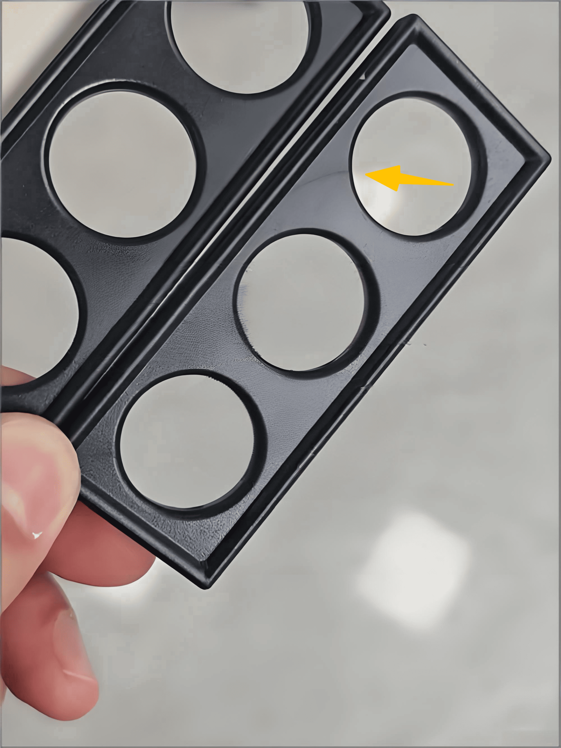 A detailed photo showing a faint but distinct weld line on the surface of a molded plastic product.