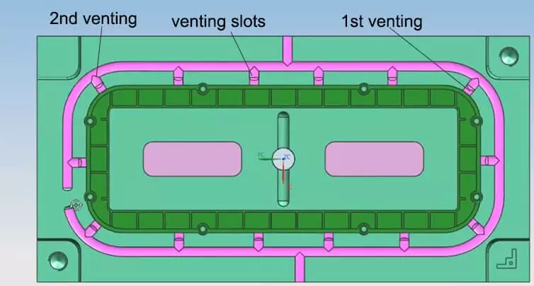 A close-up macro shot of a mold's parting line showing the tiny vent channel.